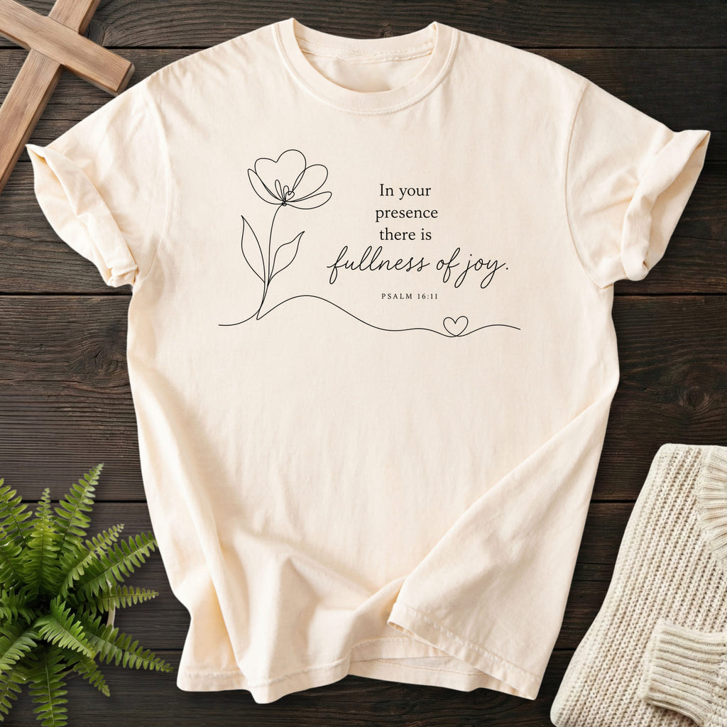 Flat lay of an Ivory Comfort Colors 1717 faith-based tee featuring flower artwork with "Fullness of Joy T-Shirt" Psalm 16:11.