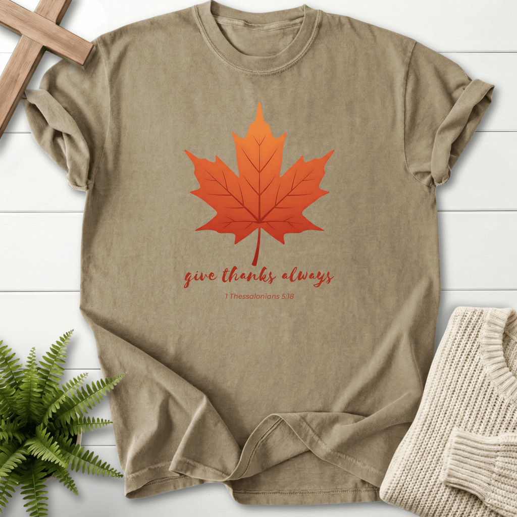 Khaki Bible verse tee with a hand-illustrated autumn maple leaf and 'Give Thanks Always', inspired by 1 Thessalonians 5:18.