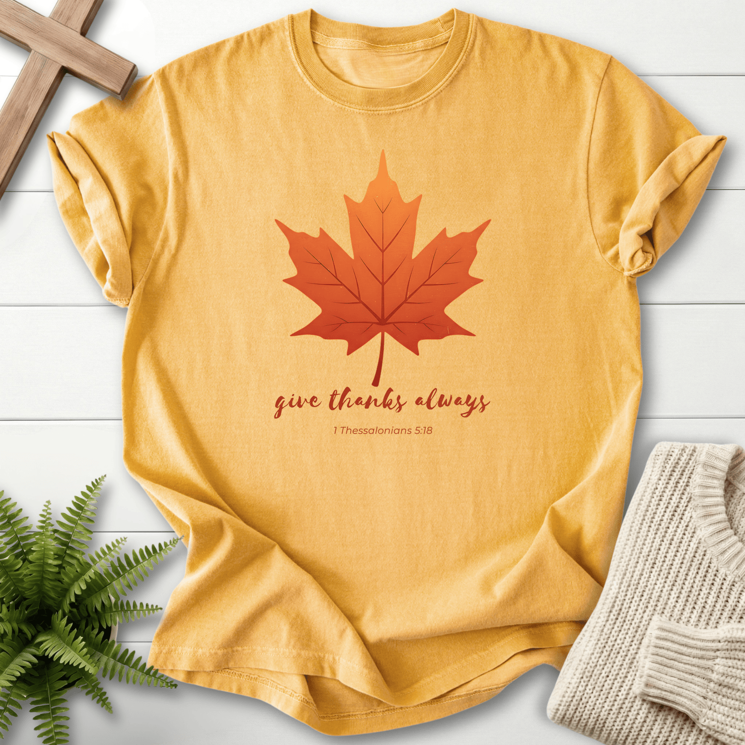 Mustard Bible verse tee with a red-orange maple leaf and 'Give Thanks Always', inspired by 1 Thessalonians 5:18.