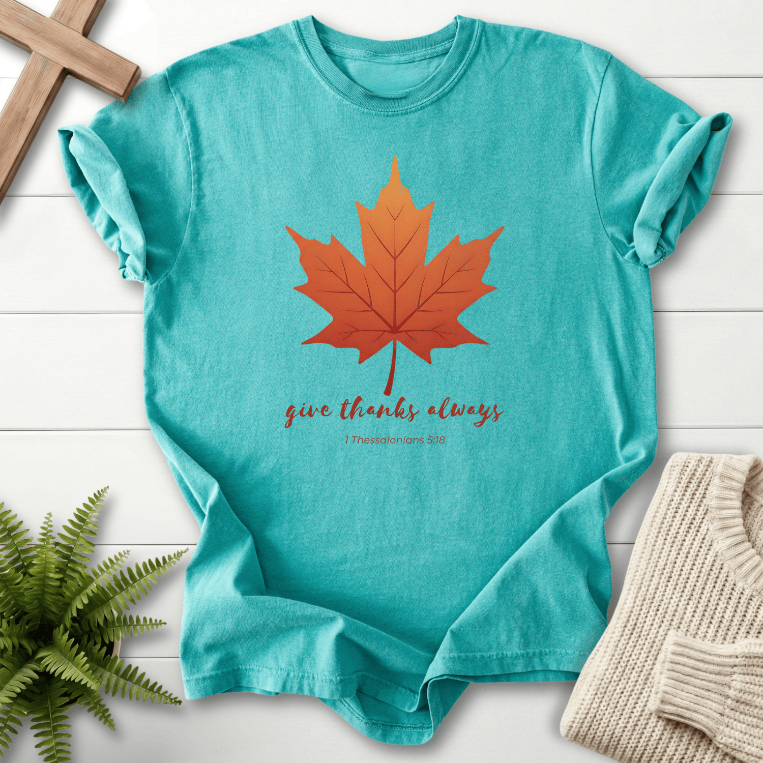 Seafoam women's faith t-shirt with an orange fall leaf and 'Give Thanks Always', inspired by 1 Thessalonians 5:18.