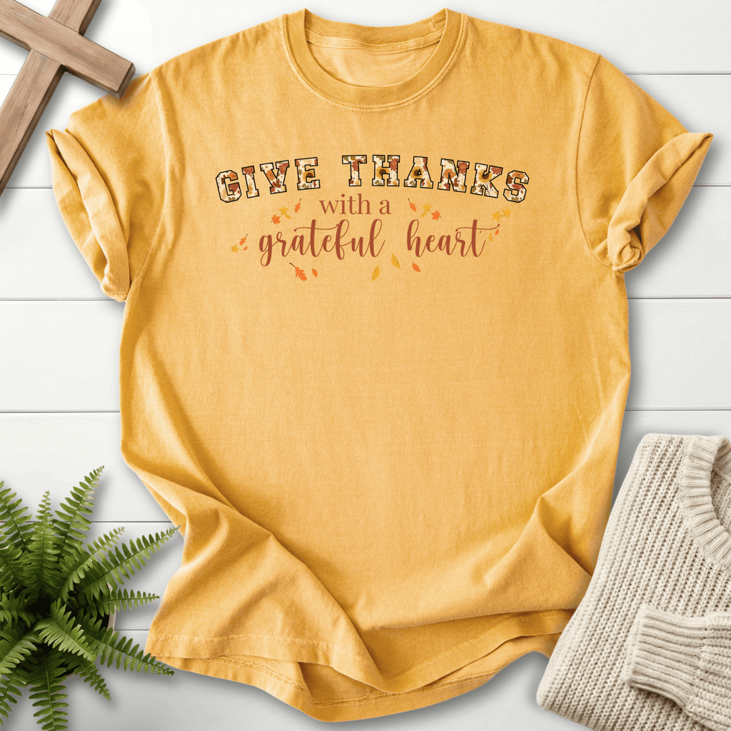Mustard women's faith t-shirt with 'Give Thanks with a Grateful Heart' in retro font and fall foliage details.