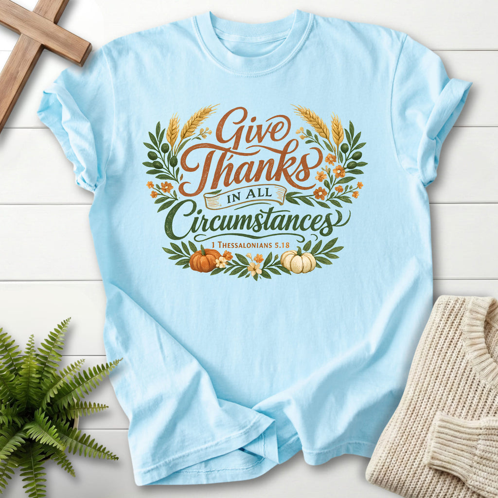 Flat lay of a Chambray Christian shirt featuring script typography with "Give Thanks in All Circumstances T-Shirt" 1 Thessalonians 5:18.