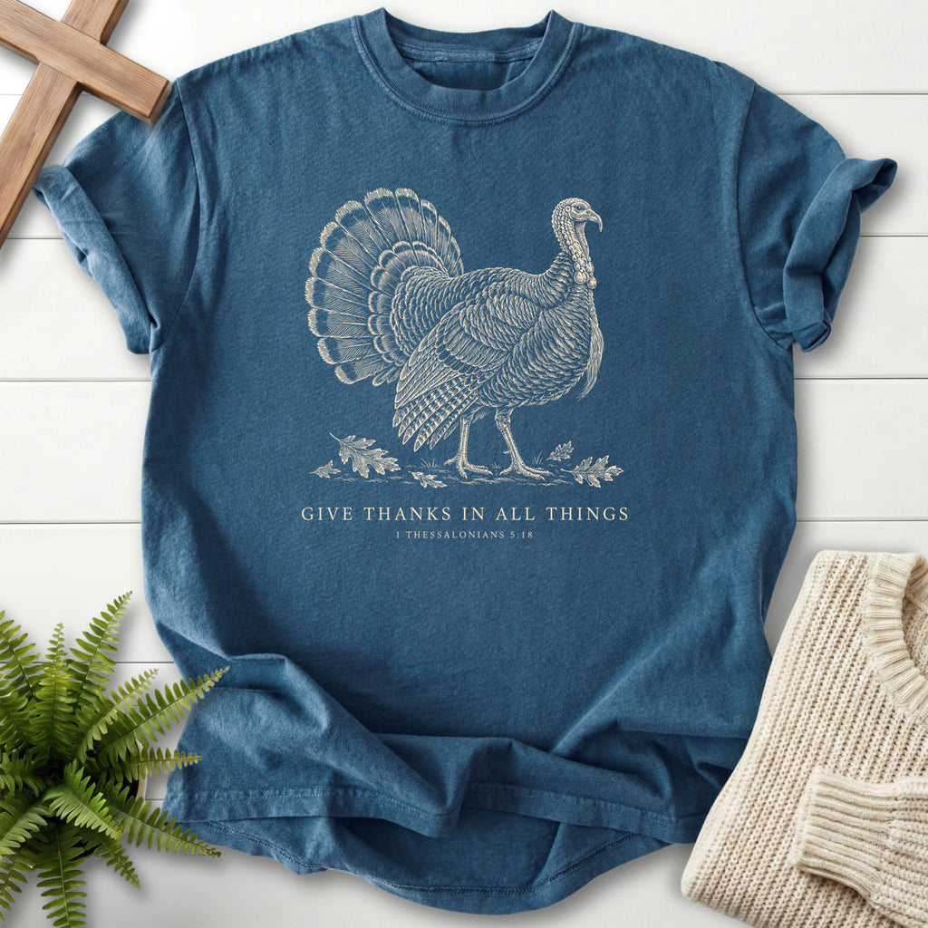Flat lay of a Midnight Christian shirt featuring "Give Thanks in All Things Turkey T-Shirt" 1 Thessalonians 5:18.