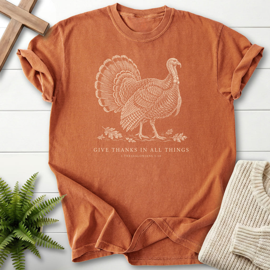Flat lay of a Yam Scripture shirt featuring "Give Thanks in All Things Turkey T-Shirt" 1 Thessalonians 5:18.