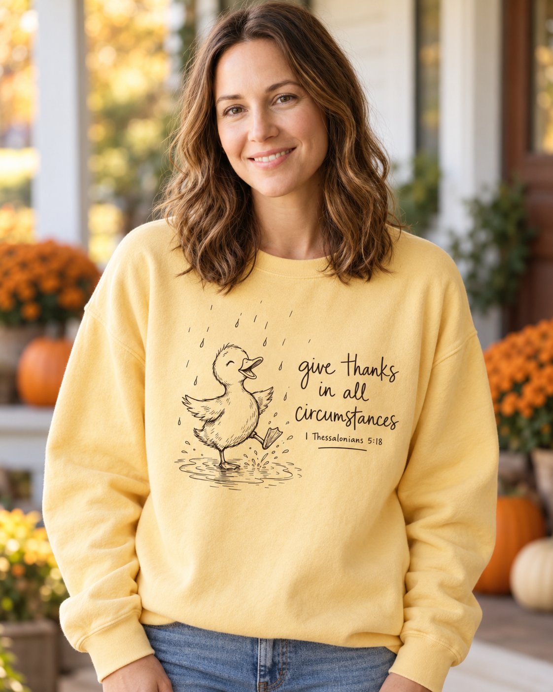 Give Thanks Rainy Day Duck, Butter women's Christian sweatshirt, lifestyle photo in cozy autumn harvest setting, rainy day duck with give thanks in all circumstances, She Wears Faith