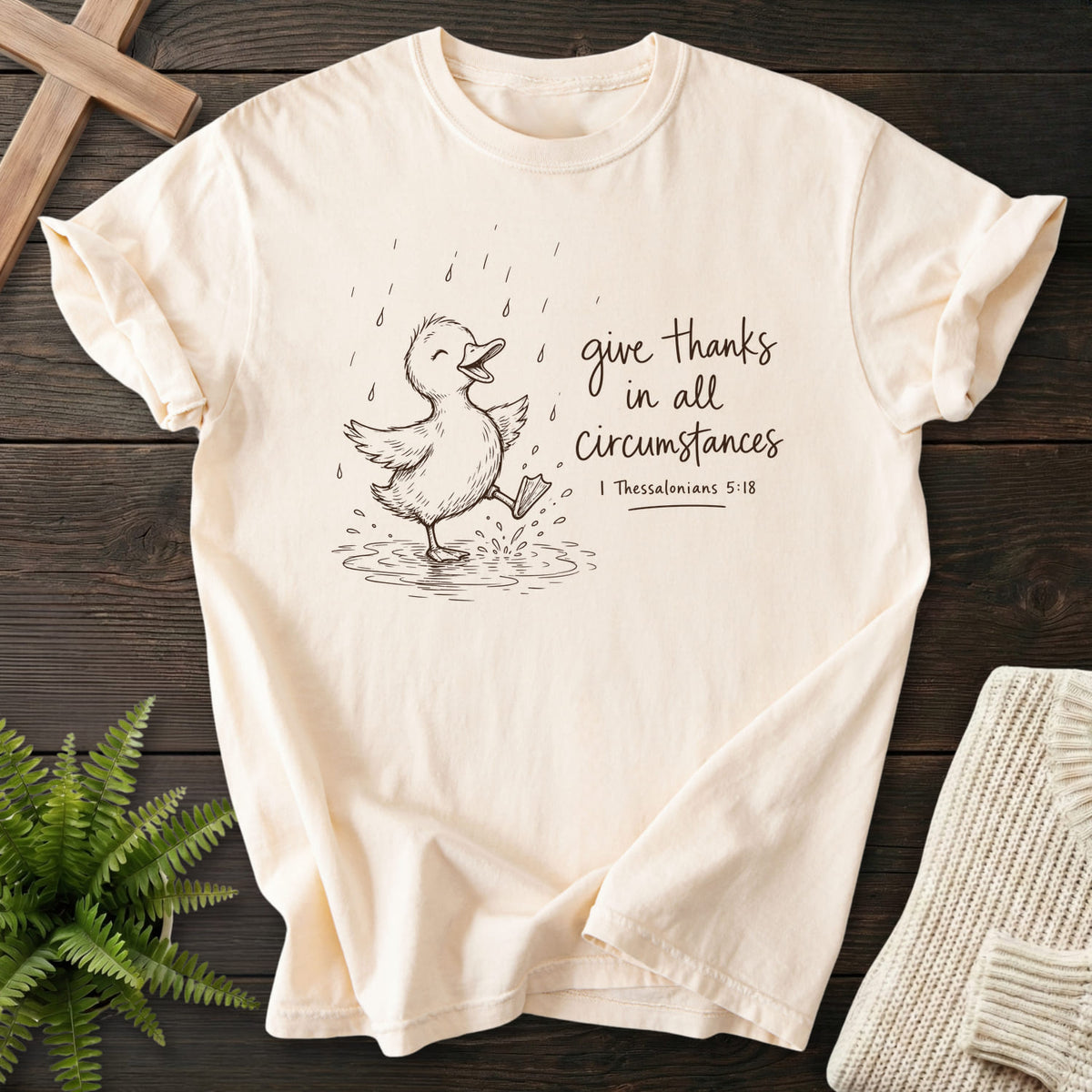 Ivory Give Thanks Rainy Day Duck T-shirt flat lay mockup, 1 Thessalonians 5:18 Christian apparel for women