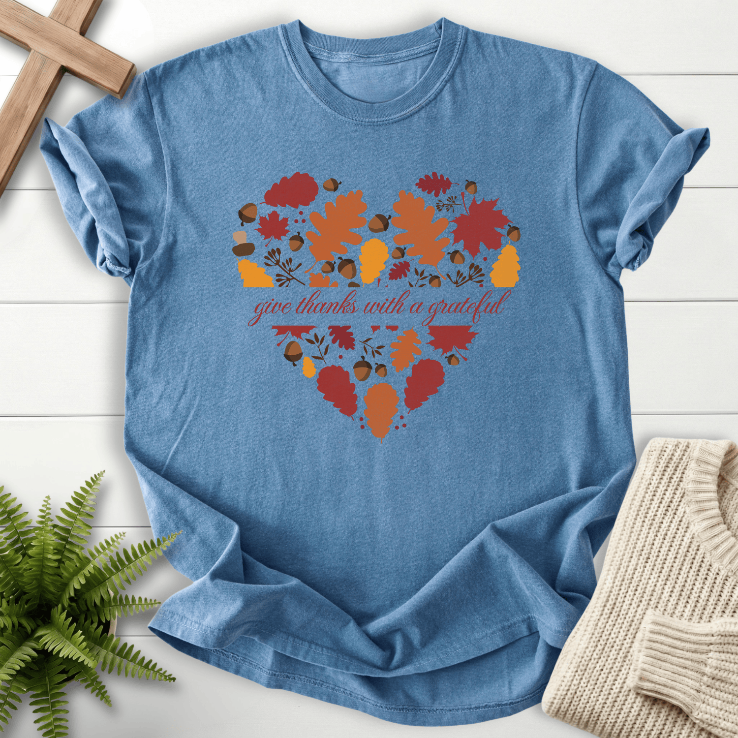 Blue Jean Bible verse tee with orange and red fall leaves shaped into a heart and 'give thanks with a grateful' in script.