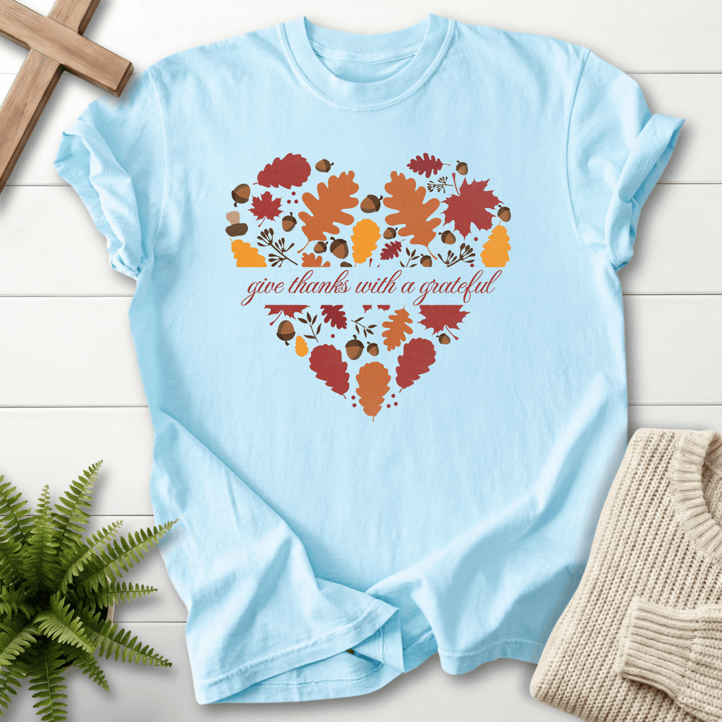 Chambray Bible verse tee with an autumn leaf and acorn heart illustration and thanksgiving script.