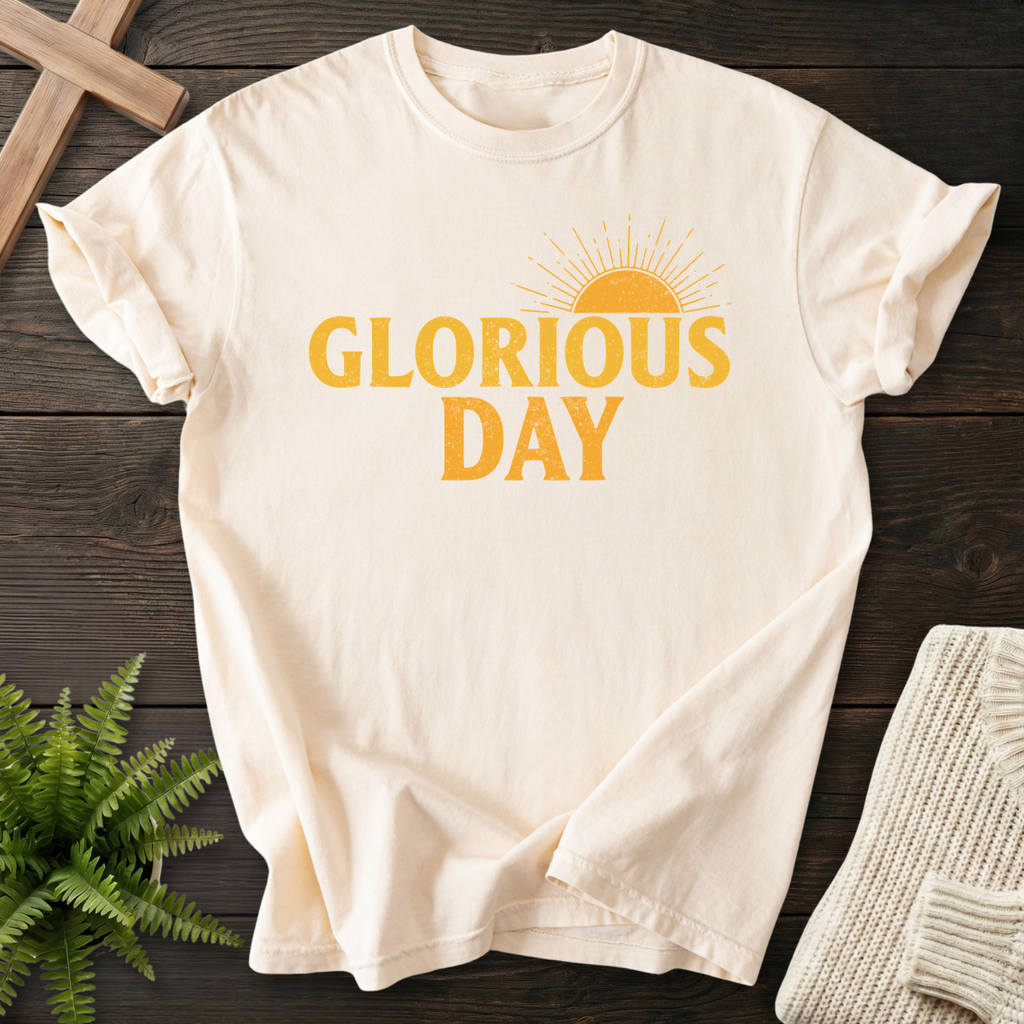 Ivory women's faith t-shirt with 'Glorious Day' in golden bold letters and a sunburst above the text.