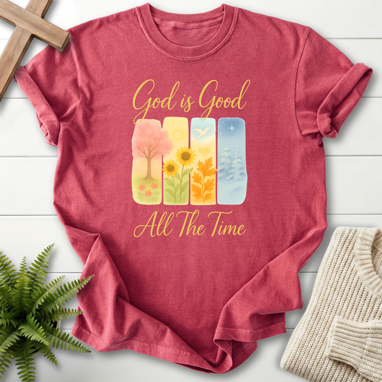 Crimson women's faith t-shirt with four watercolor seasonal panels and 'God is Good All The Time'.