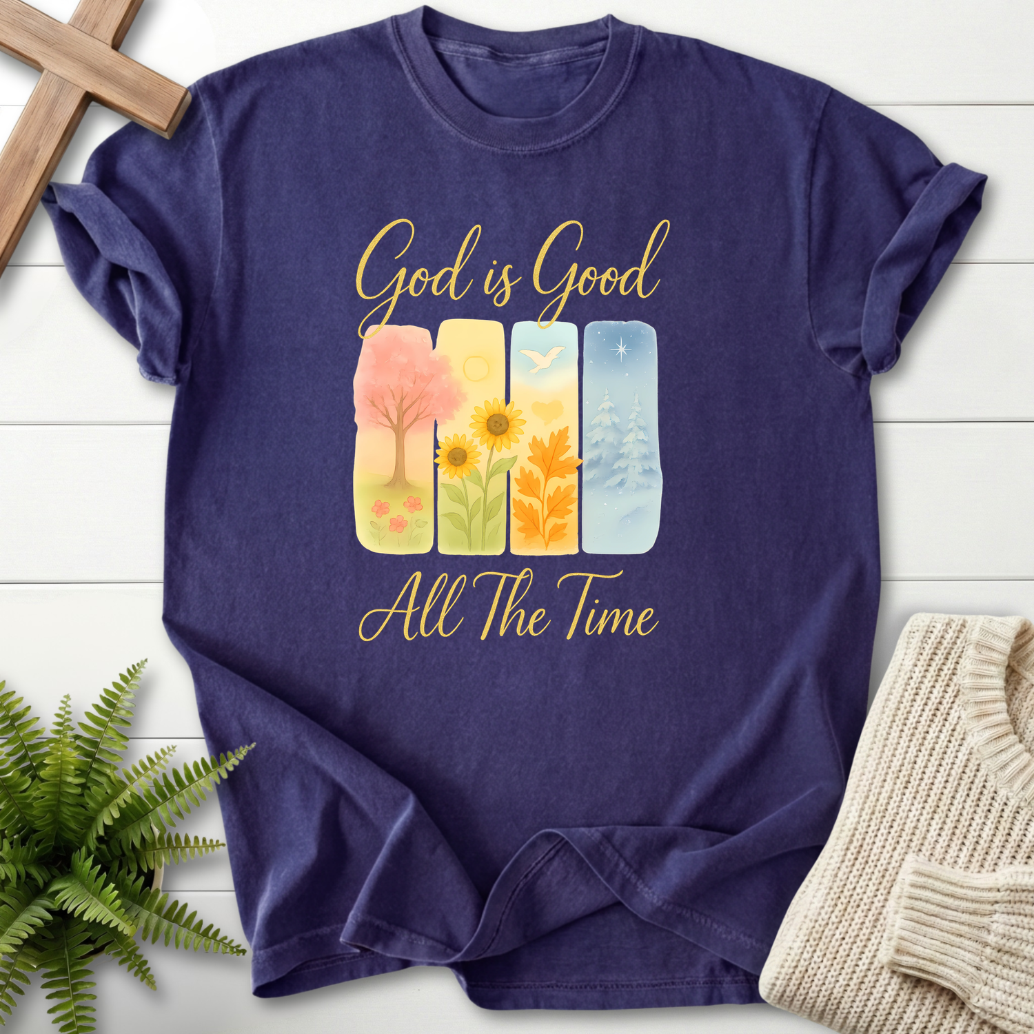Grape women's faith t-shirt with a four-season watercolor illustration and 'God is Good All The Time' in gold script.