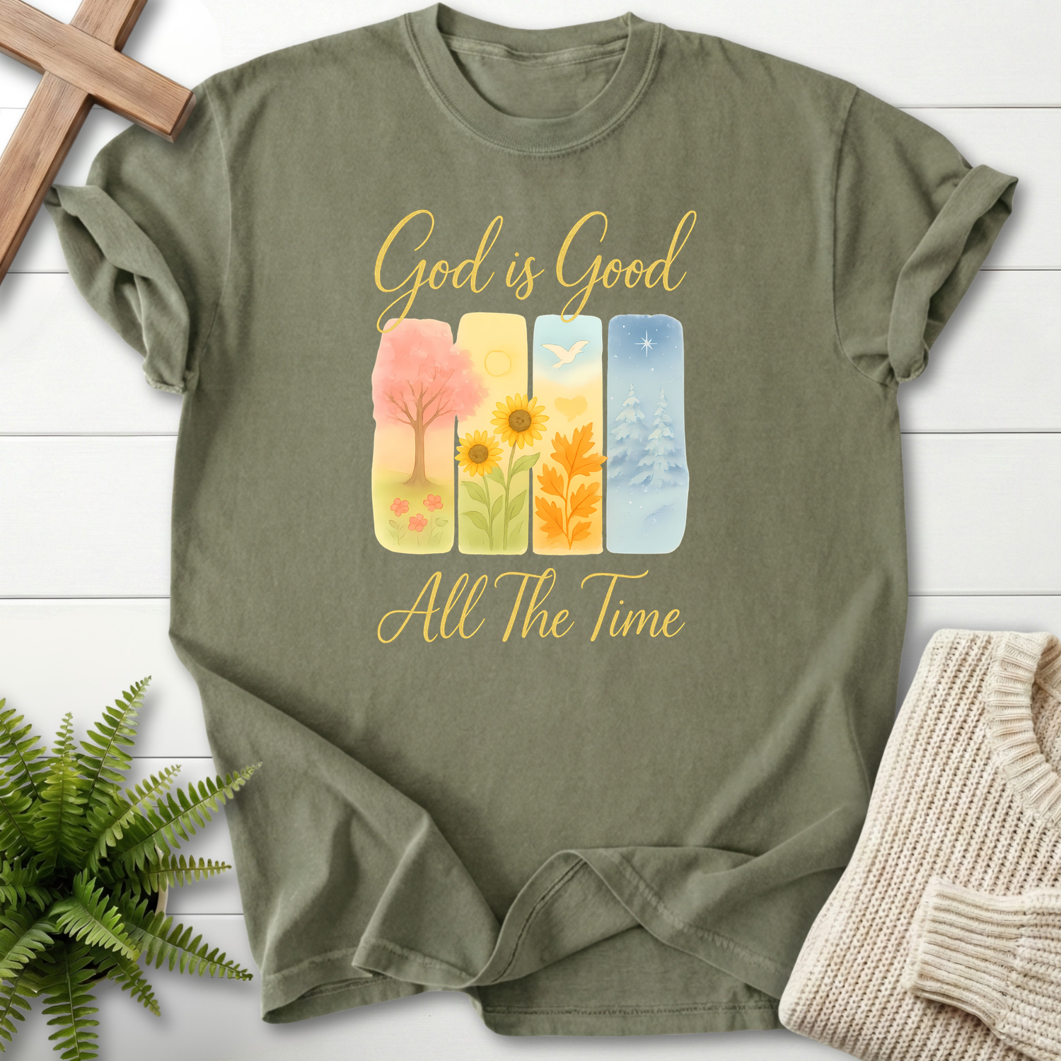 Sage women's faith t-shirt with spring, summer, fall, and winter watercolor panels and 'God is Good All The Time'.