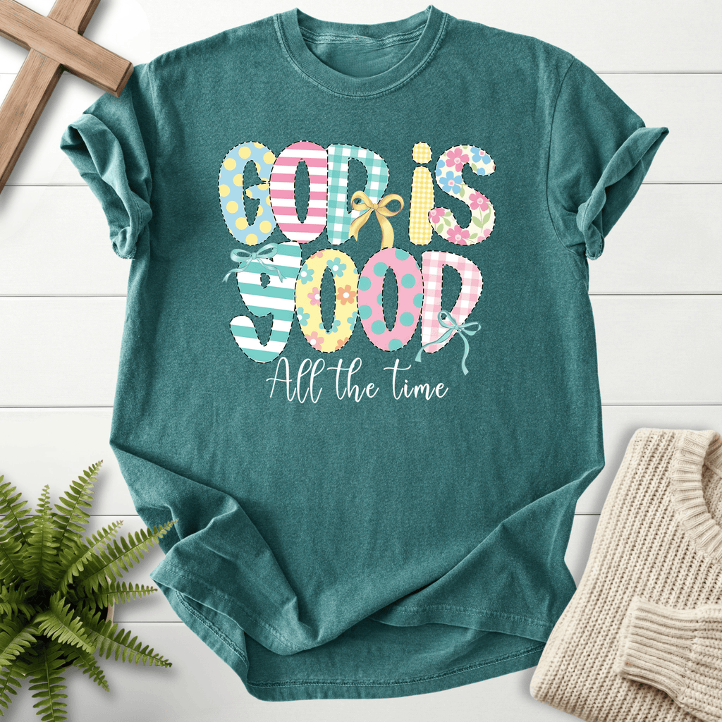 Blue Spruce women's faith t-shirt with a patchwork 'God Is Good All The Time' graphic and ribbon bow, Comfort Colors 1717.
