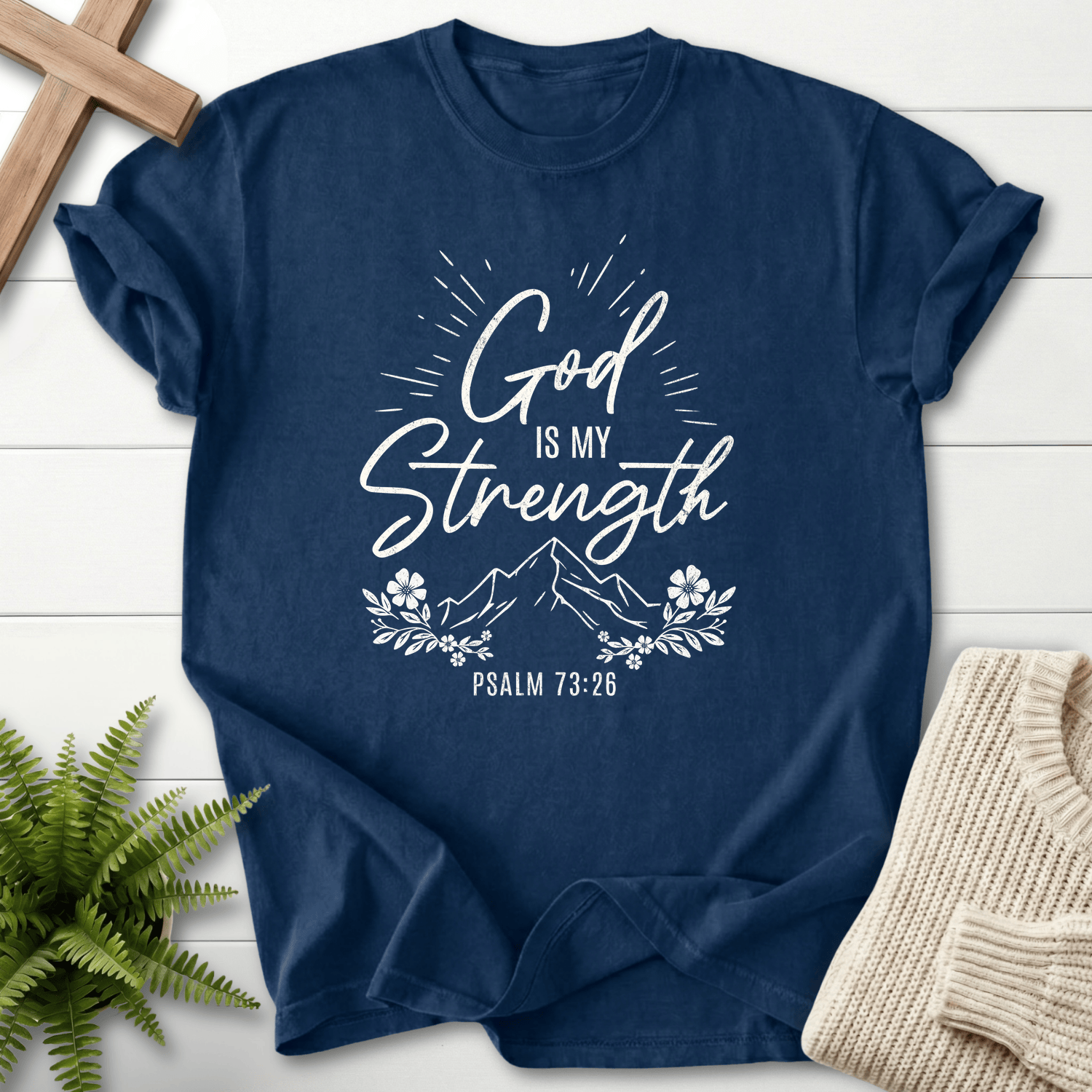 Navy Bible verse tee with radiant 'God Is My Strength' lettering and floral framing, Comfort Colors 1717, inspired by Psalm 73:26.