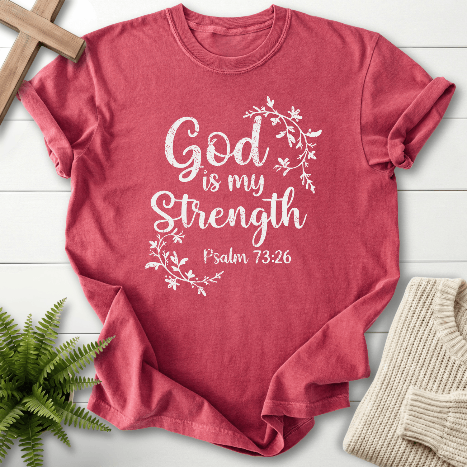 Crimson Bible verse tee with a vine leaf wreath and distressed white 'God is my Strength', inspired by Psalm 73:26.