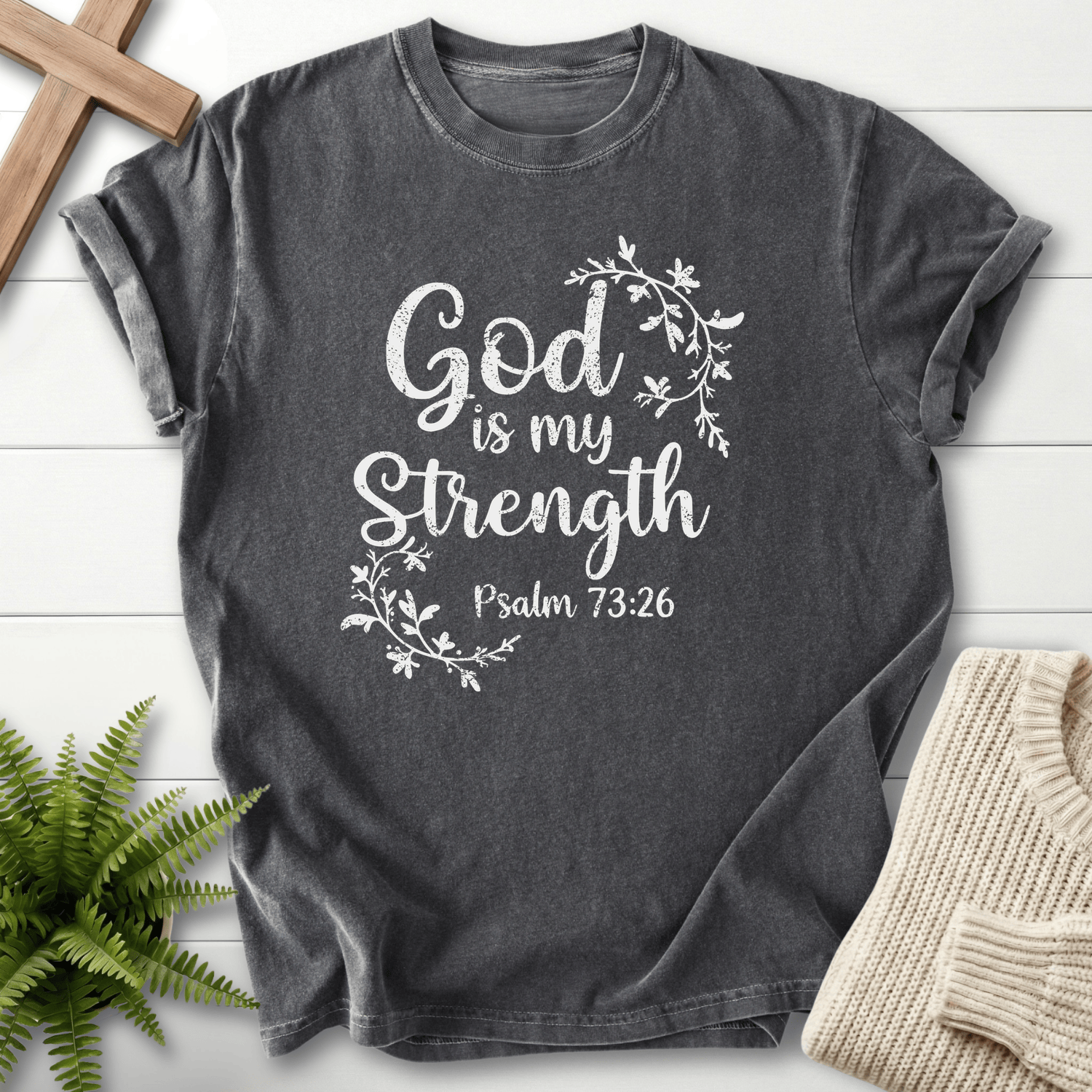 Pepper Bible verse tee with flowing botanical vines and white 'God is my Strength' lettering, inspired by Psalm 73:26.