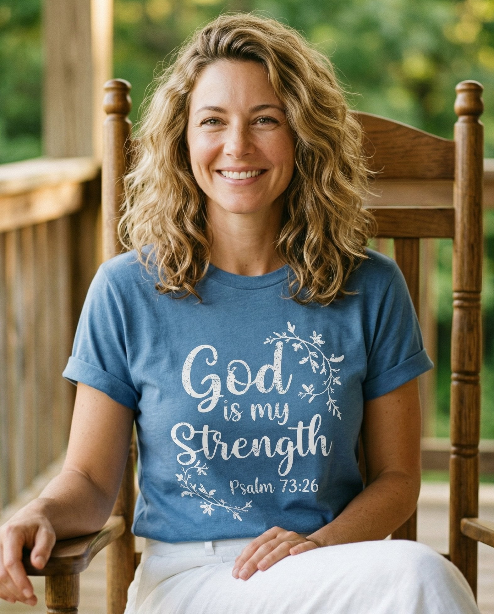 God is My Strength Vine Graphic – Blue Jean women's Christian tee, lifestyle photo in sunny porch – Flowing vine and leaf wreath framing 'God is my Strength' in script wi – Psalm 73:26 – She Wears Faith