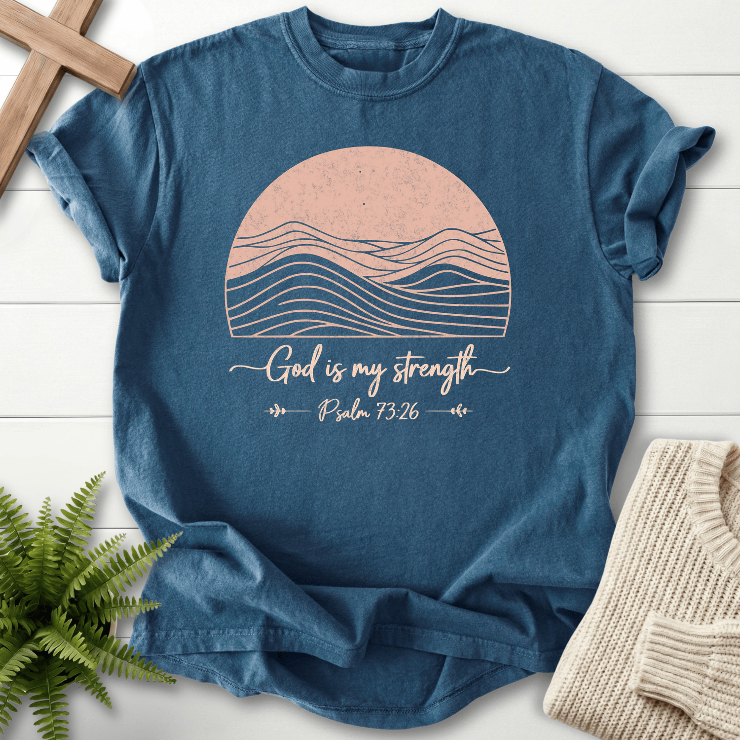 Midnight blue Bible verse tee with a line-art mountain landscape and 'God is My Strength', inspired by Psalm 73:26.