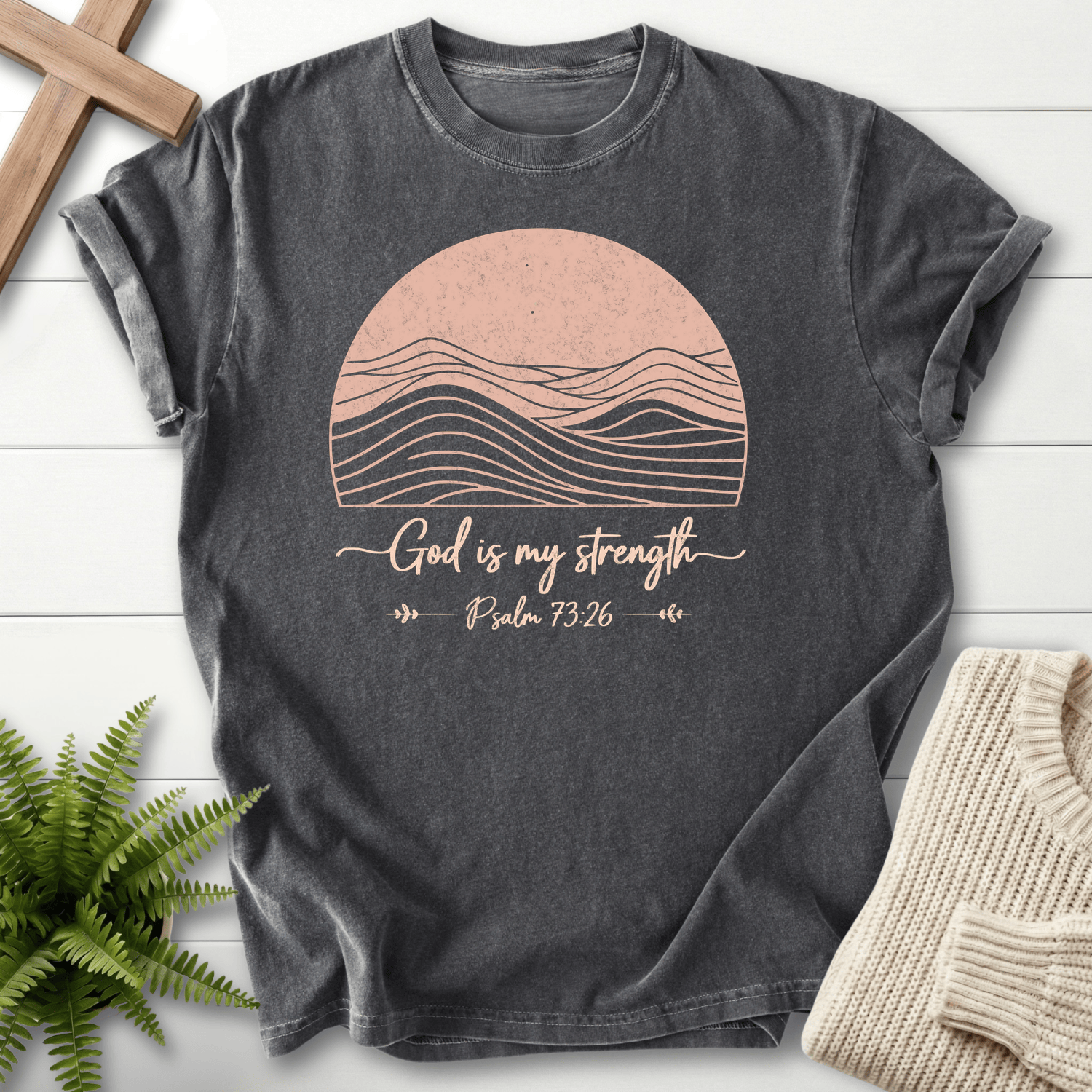 Pepper gray Bible verse tee with minimalist mountain peaks inside a sun circle and 'God is My Strength', inspired by Psalm 73:26.