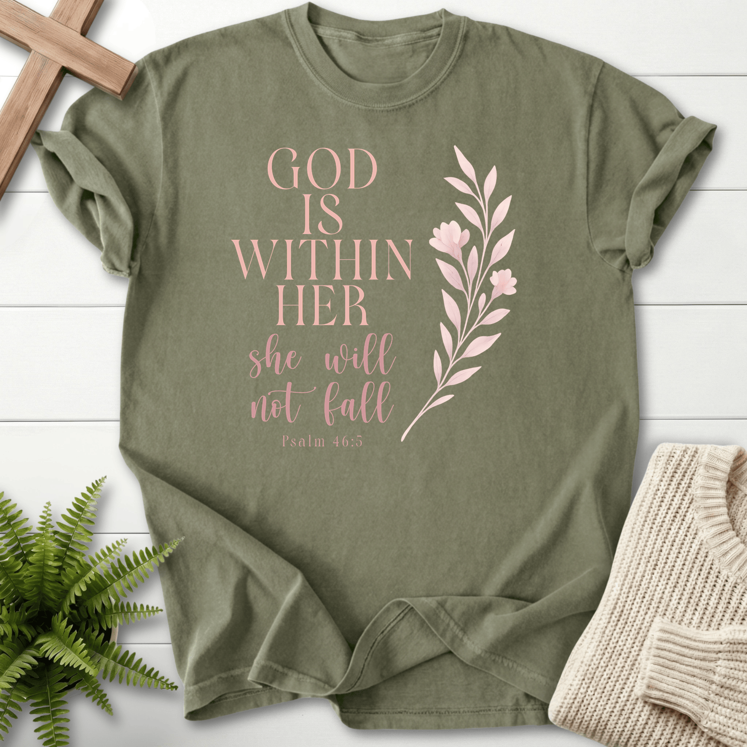 Sage women's faith t-shirt with stacked serif 'God is Within Her' and a rose gold floral branch, inspired by Psalm 46:5.