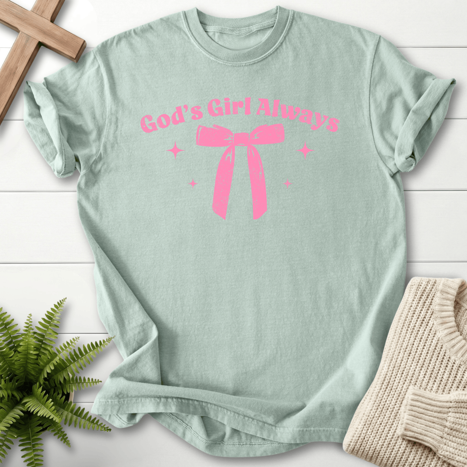 Bay women's faith t-shirt with a tonal ribbon bow graphic and 'God's Girl Always' in curved lettering.