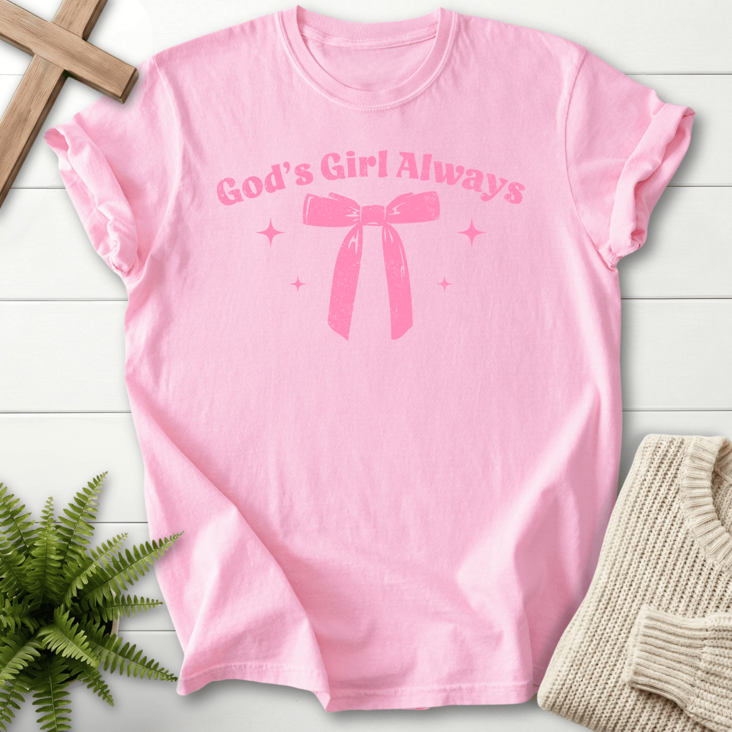 Blossom pink women's faith t-shirt with 'God's Girl Always' text and a ribbon bow with sparkles, Comfort Colors 1717.
