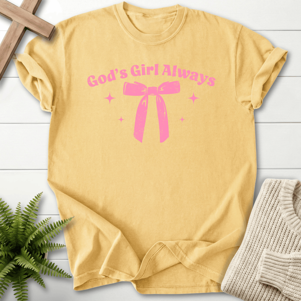Butter women's faith t-shirt with a bow accent and 'God's Girl Always' in a coquette-inspired print.