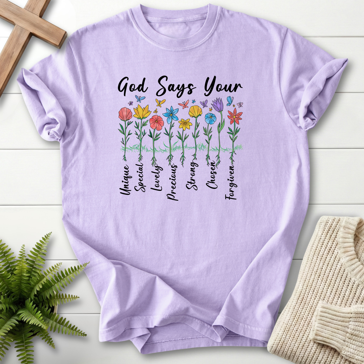 Orchid women's faith t-shirt with an illustrated floral affirmation garden design and 'God Says You Are' header.