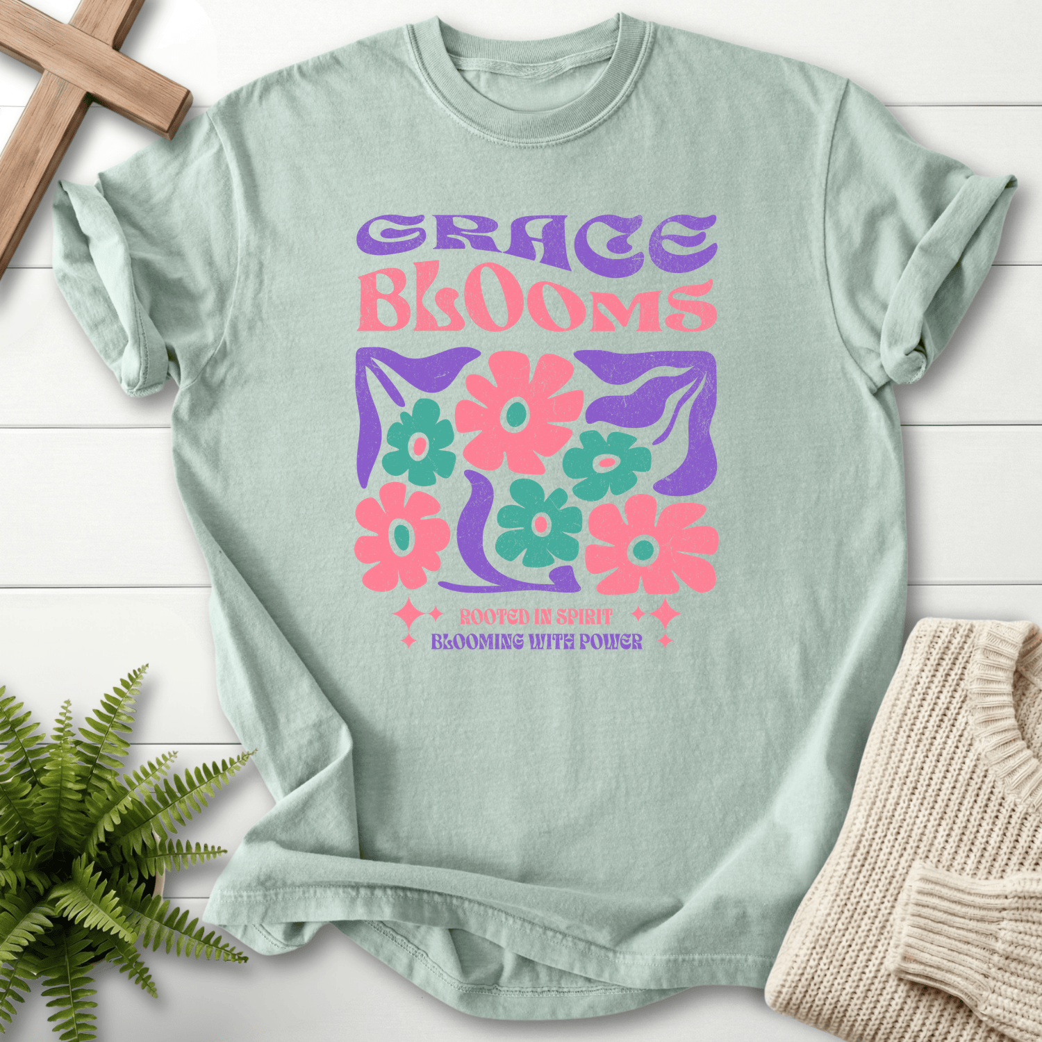 Bay blue women's faith t-shirt with 'Grace Blooms, Rooted in Spirit, Blooming with Power' in a vintage floral retro design.