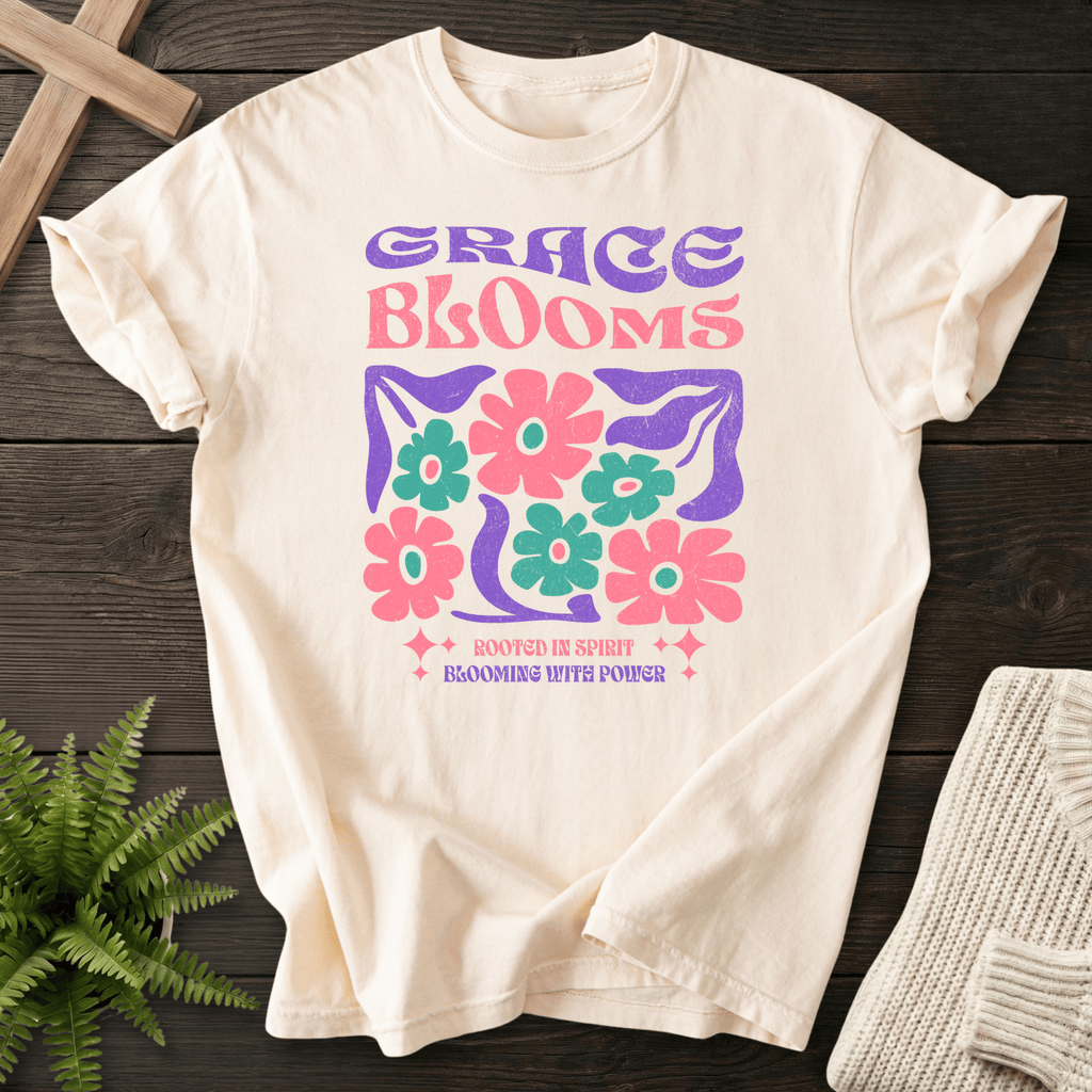 Ivory women's faith t-shirt with retro groovy 'Grace Blooms' lettering and a bold daisy flower graphic.