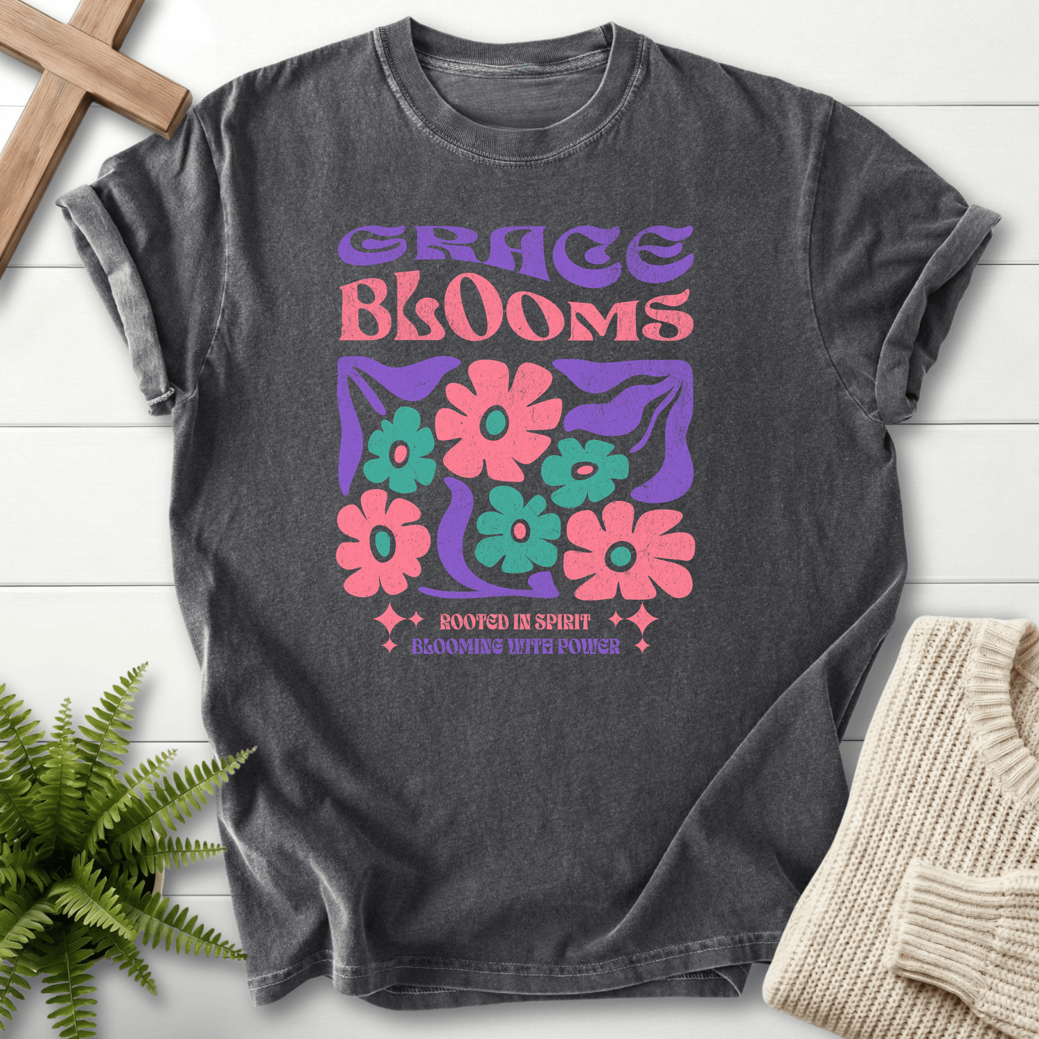 Pepper women's faith t-shirt with bold retro 'Grace Blooms' and a colorful daisy print in purple and pink.