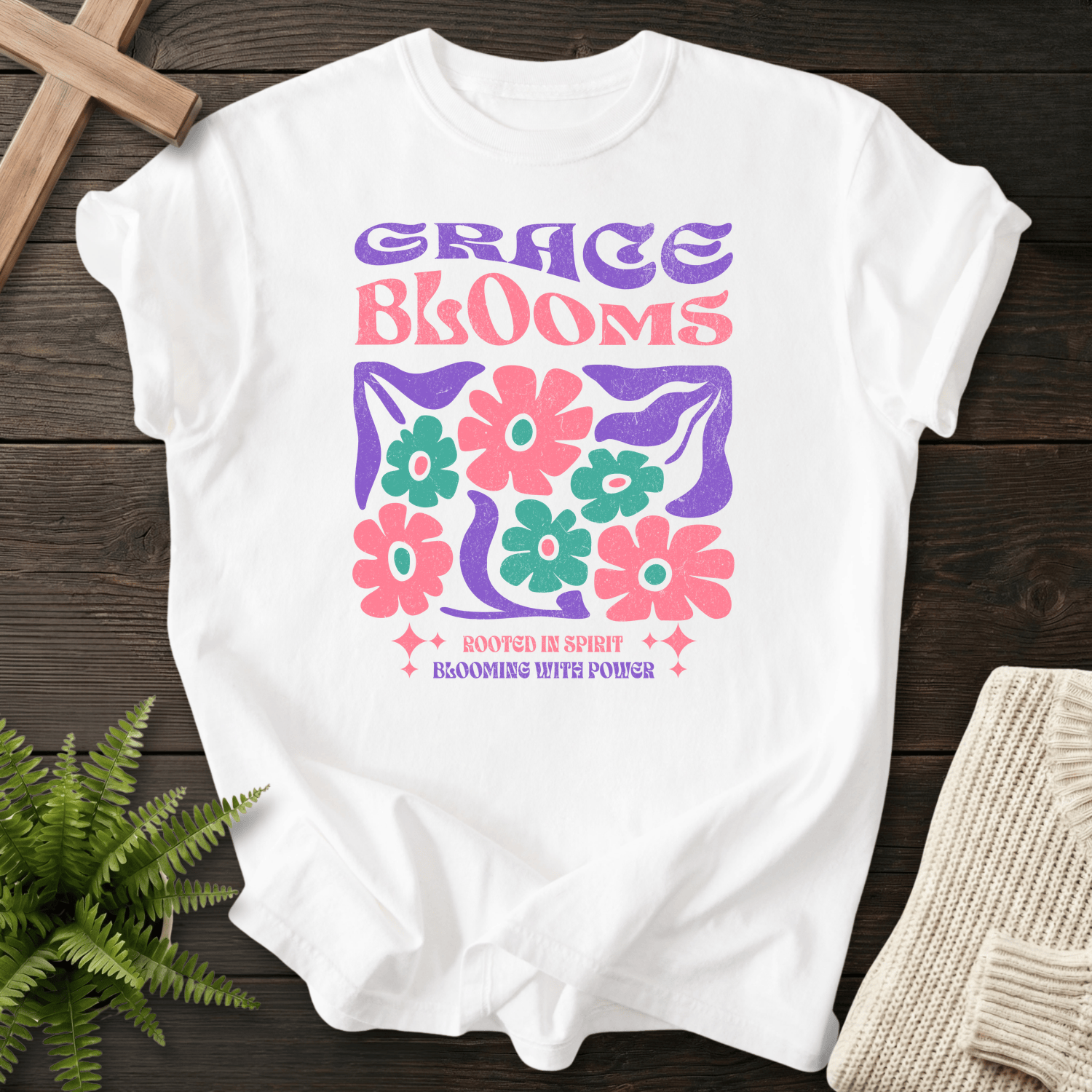 White women's faith t-shirt with retro 'Grace Blooms, Rooted in Spirit, Blooming with Power' floral graphic.