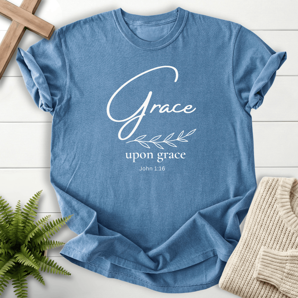 Blue Jean Bible verse tee with elegant gold 'Grace upon grace' lettering and a leaf detail, inspired by John 1:16.