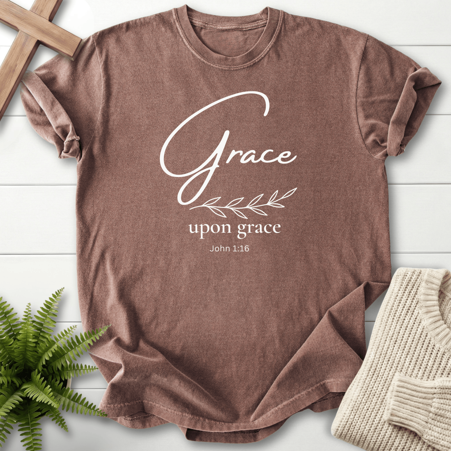 Espresso Bible verse tee with gold minimalist 'Grace upon grace' lettering and a small leaf sprig, inspired by John 1:16.