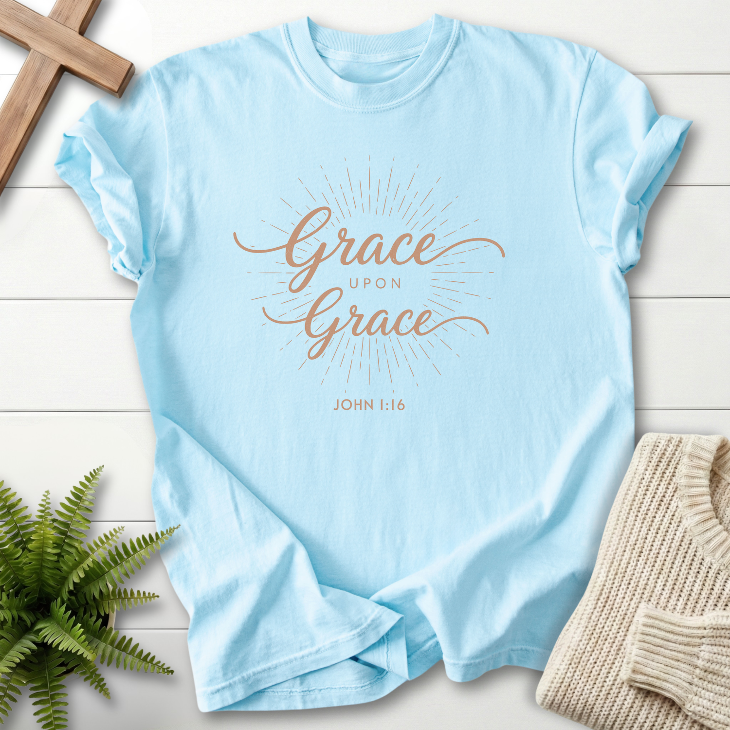 Chambray Bible verse tee with rose-tone cursive 'Grace Upon Grace' and a sunburst accent, inspired by John 1:16.