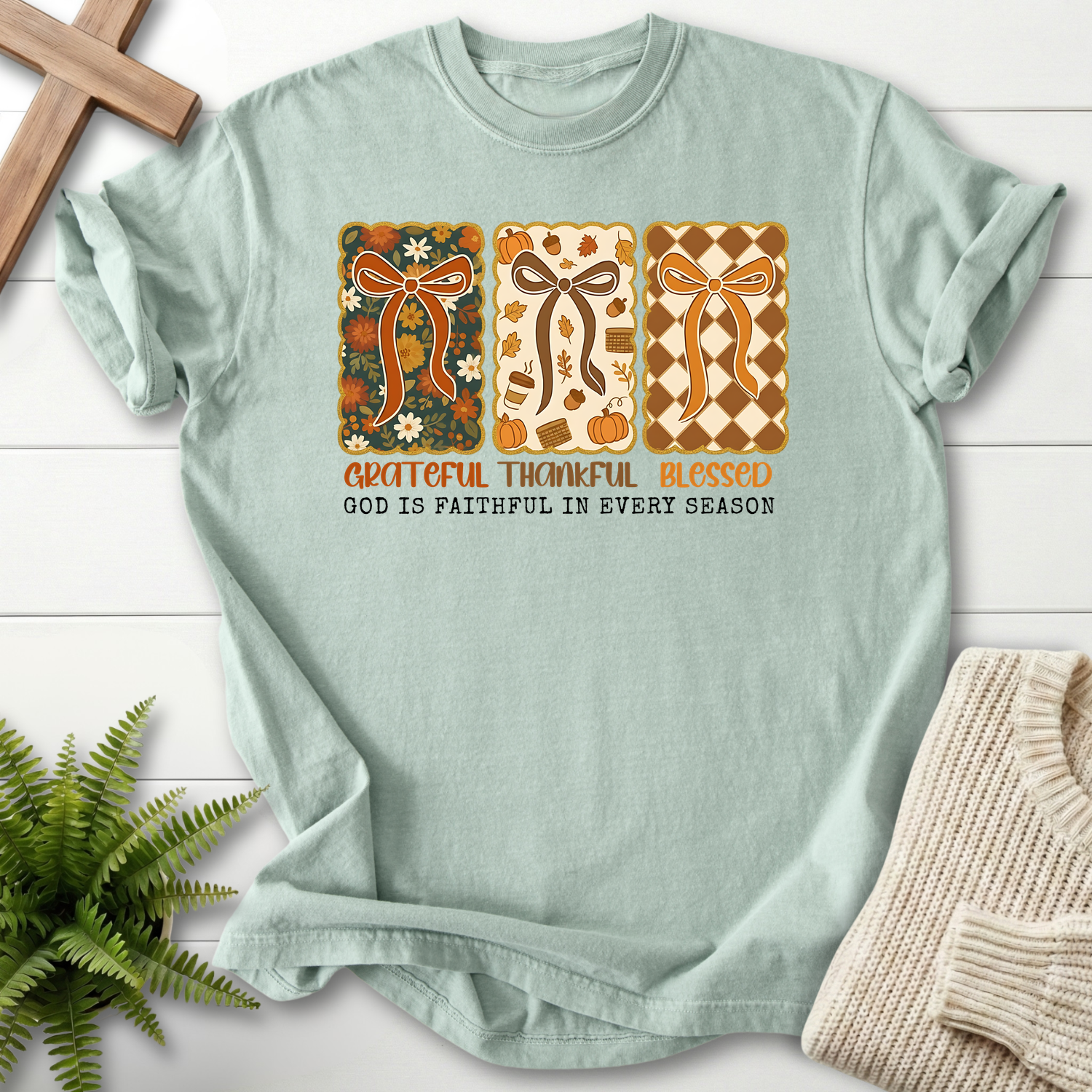 Bay women's faith t-shirt with three decorative fall bow panels and 'God is Faithful in Every Season'.