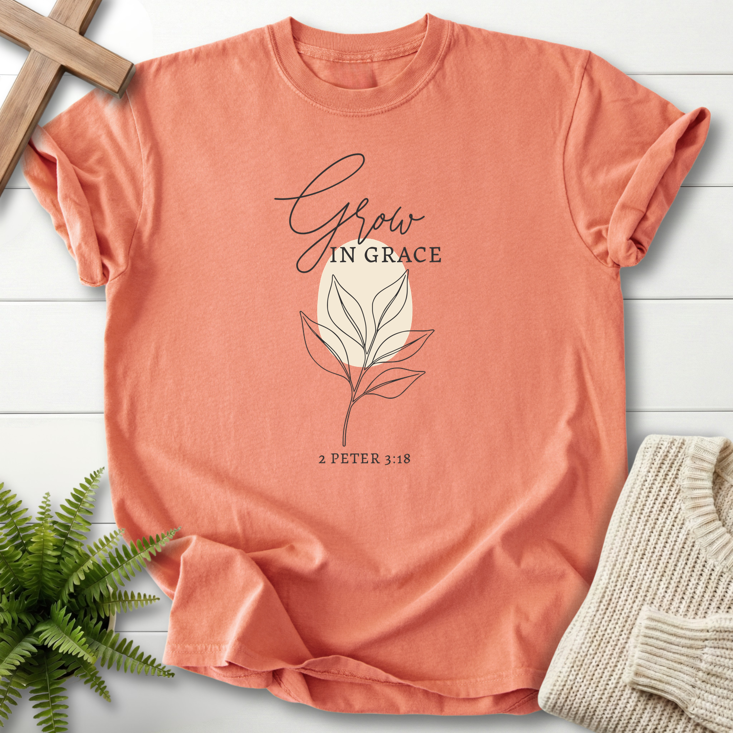 Terracotta Bible verse tee with a simple botanical leaf illustration and 'Grow in Grace', inspired by 2 Peter 3:18.