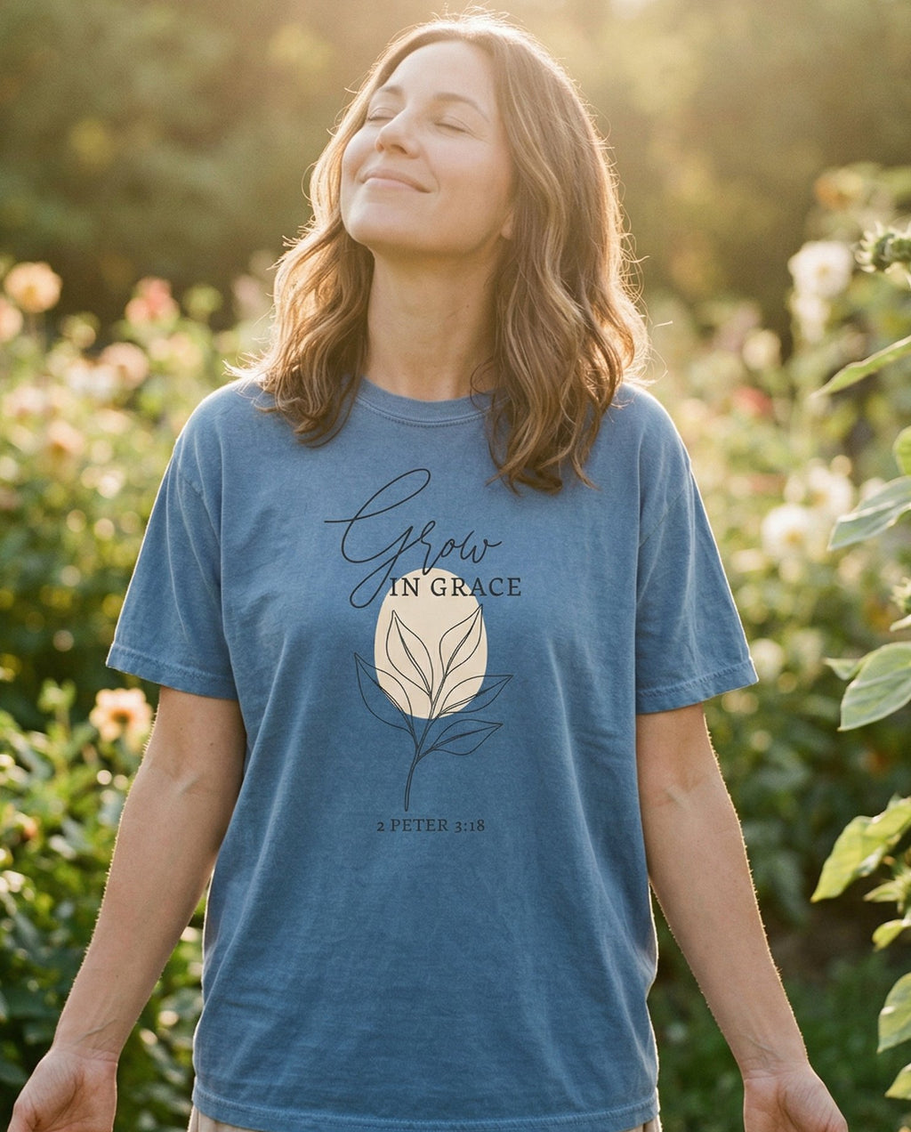 Grow in Grace – Blue Jean women's Christian tee, lifestyle photo in outdoor garden – Minimalist line-art sprouting plant with broad leaves in a simple bota – 2 Peter 3:18 – She Wears Faith