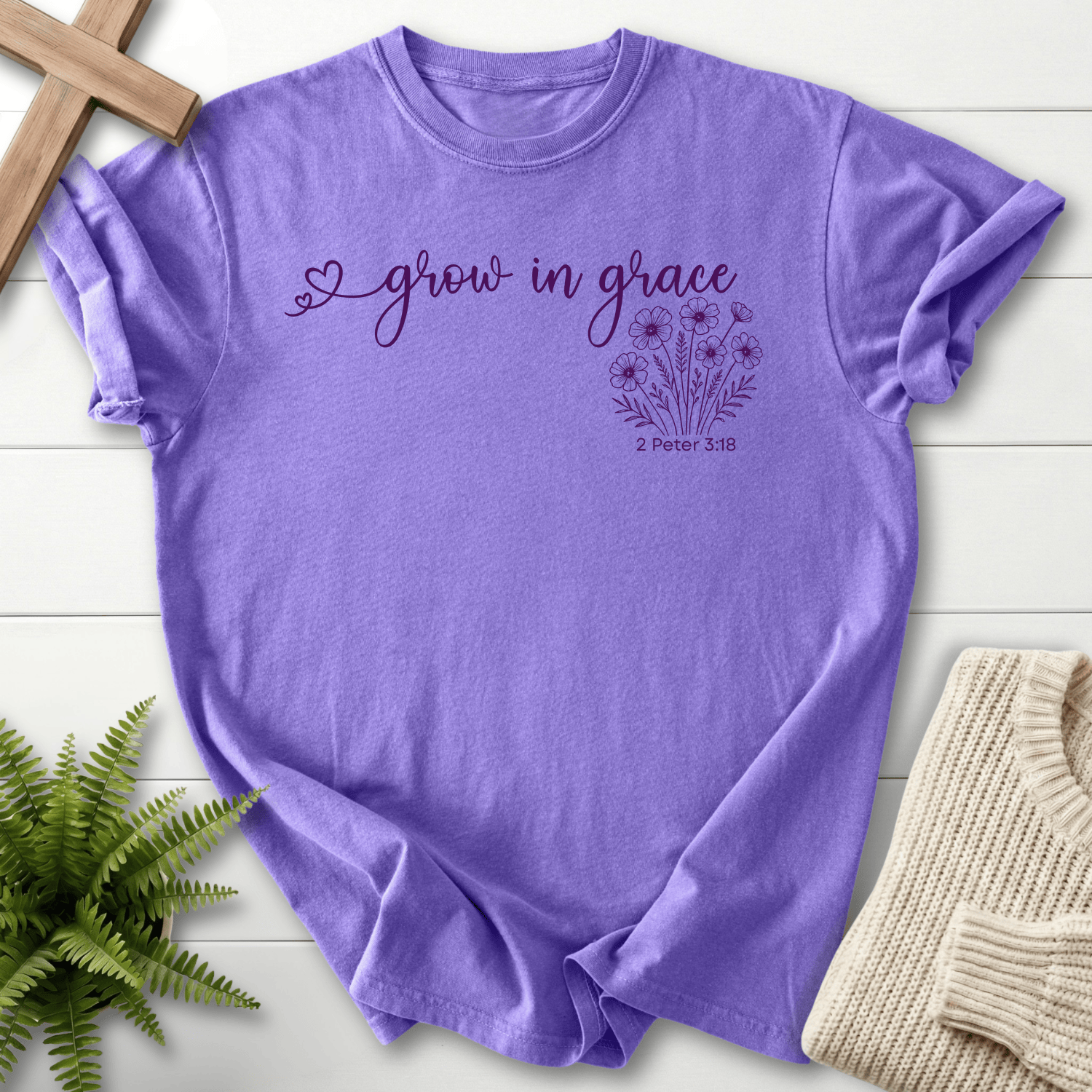 Violet women's faith t-shirt with 'grow in grace' cursive lettering and a wildflower bouquet print, inspired by 2 Peter 3:18.