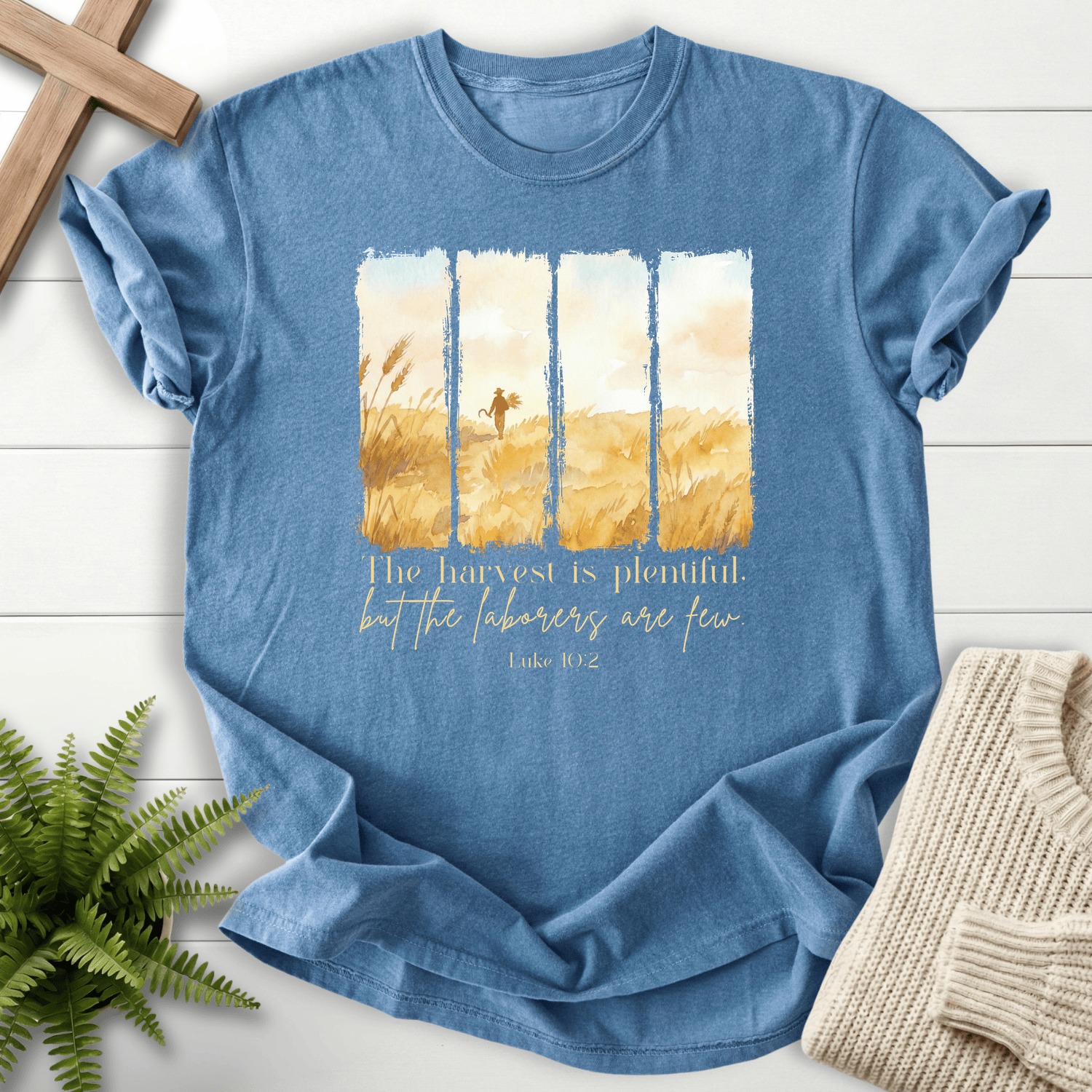 Blue Jean Bible verse tee with a watercolor wheat harvest scene in four panels and 'The harvest is plentiful', inspired by Luke 10:2.