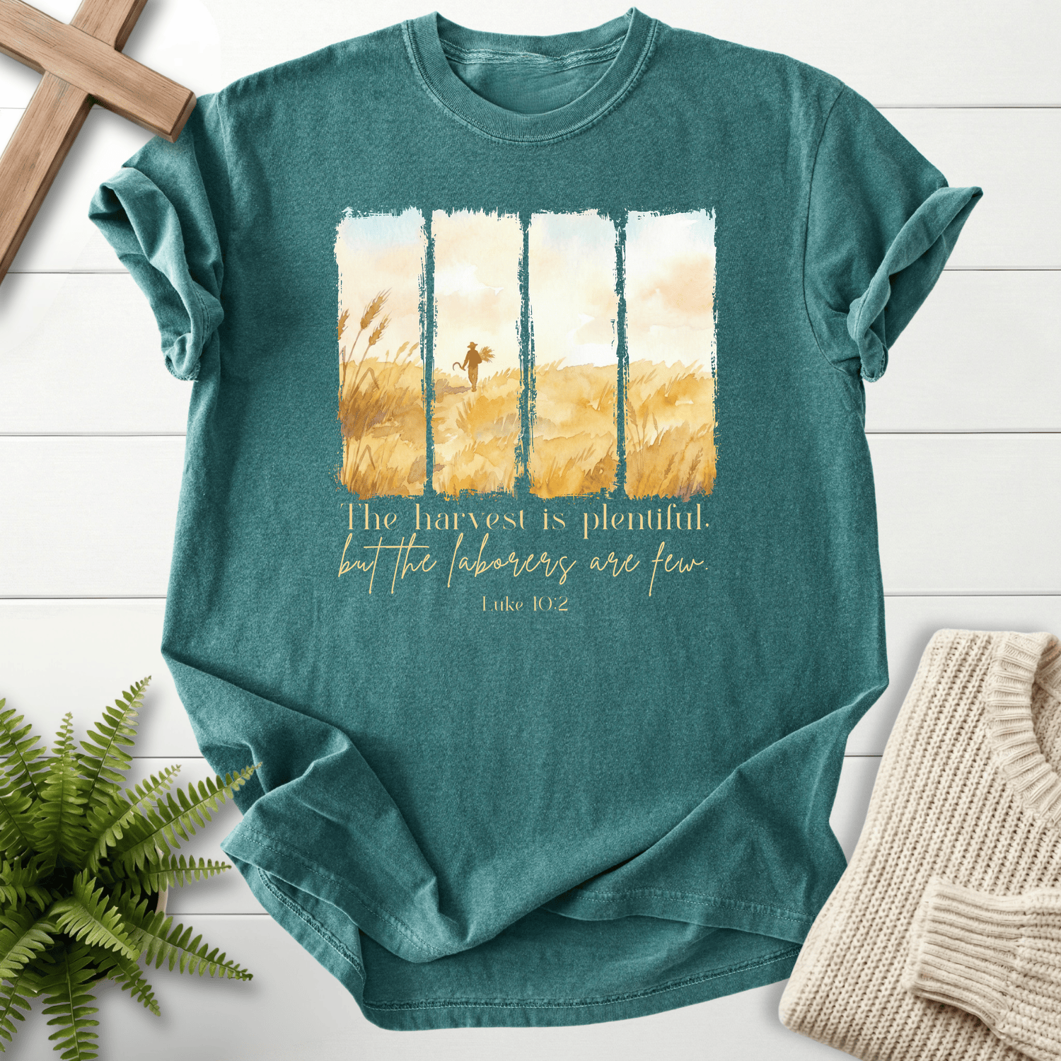 Blue Spruce women's faith t-shirt with four harvest field watercolor panels and Luke 10:2 scripture print.