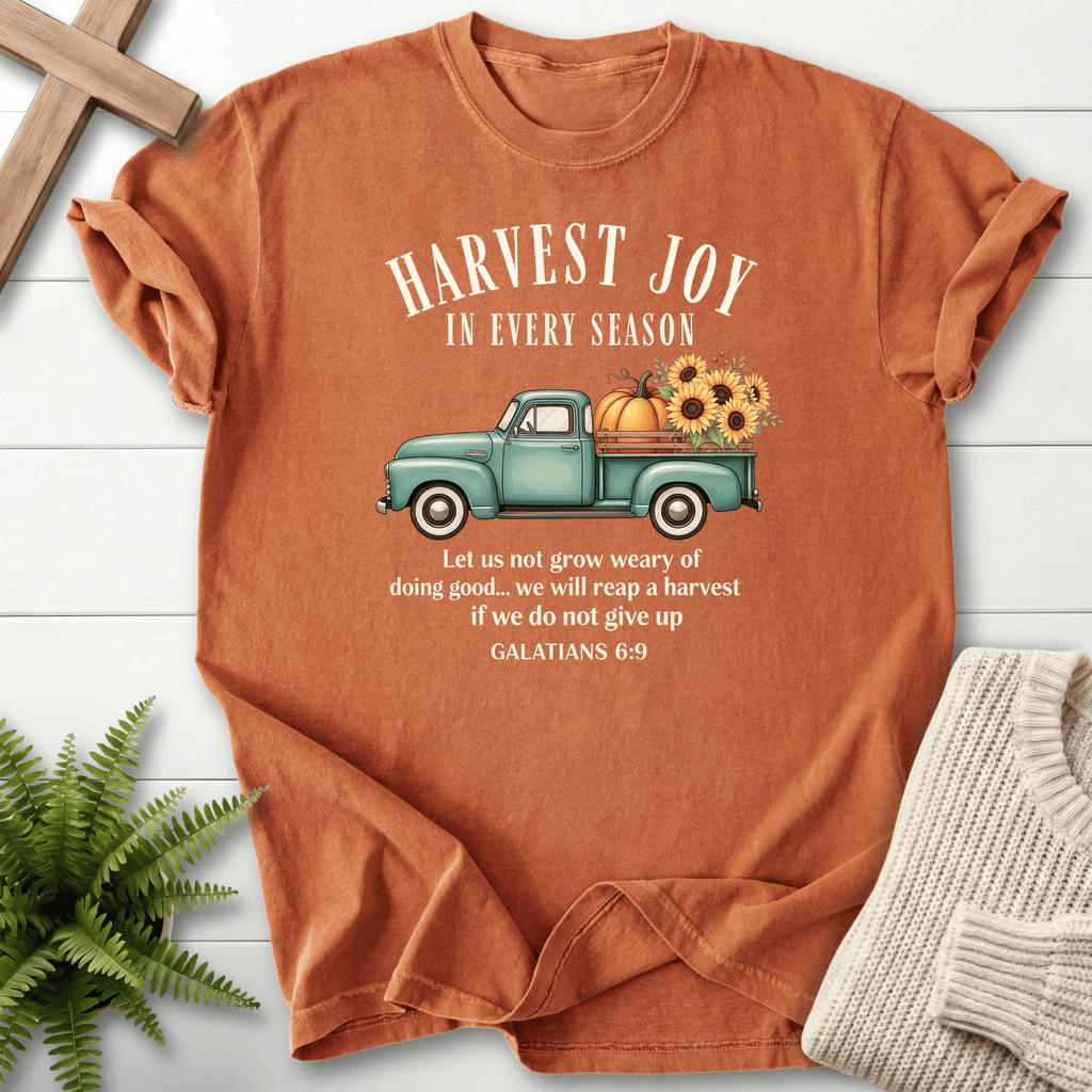 Yam women's faith t-shirt with a vintage teal truck carrying pumpkins and sunflowers, inspired by Galatians 6:9.