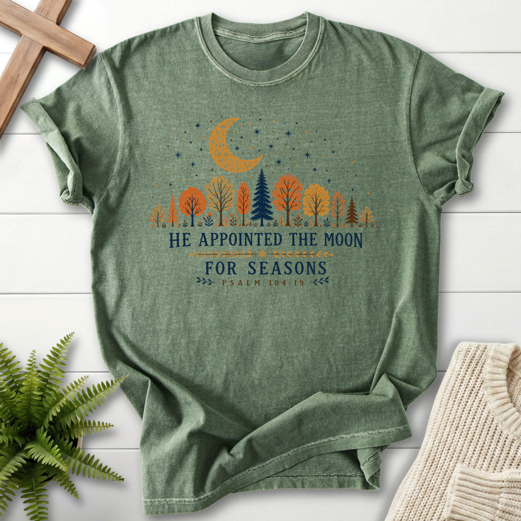 Flatlay of a Moss Christian graphic tee with floral line art with "He Appointed the Moon for Seasons T-Shirt" Psalm 104:19.