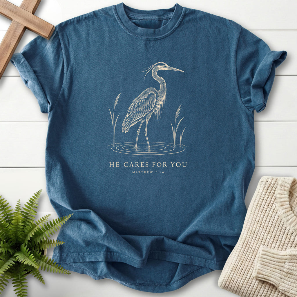 Flat lay of a Midnight women's Christian tee featuring "He Cares for You T-Shirt" The Matthew 6:26.