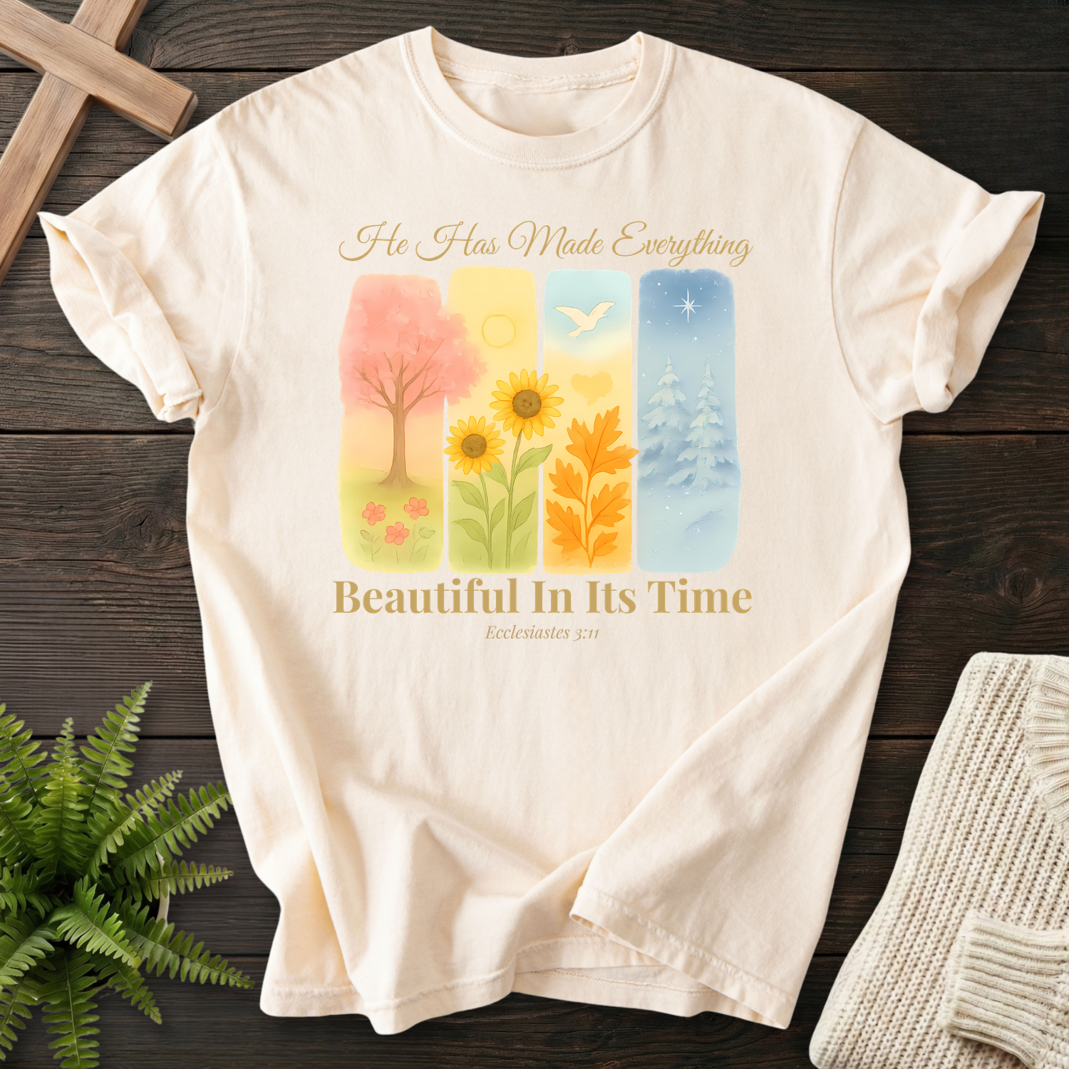 Ivory Bible verse tee with four watercolor seasonal panels and 'He Has Made Everything Beautiful In Its Time', inspired by Ecclesiastes 3:11.