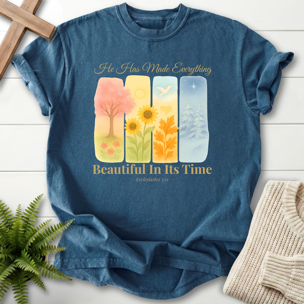 Midnight Bible verse tee with four seasonal watercolor panels and 'He Has Made Everything Beautiful in Its Time,' inspired by Ecclesiastes 3:11.