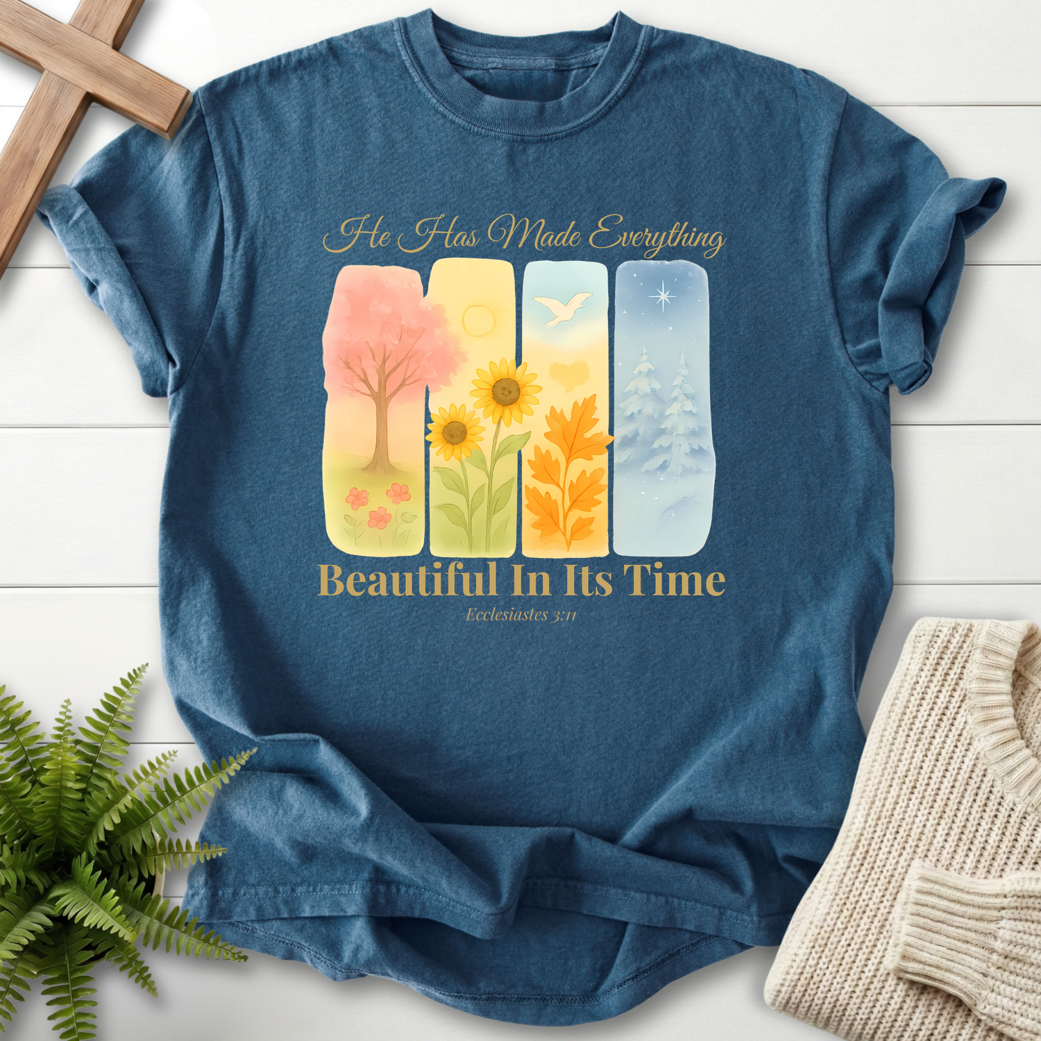 Midnight Bible verse tee with four seasonal watercolor panels and 'He Has Made Everything Beautiful in Its Time,' inspired by Ecclesiastes 3:11.