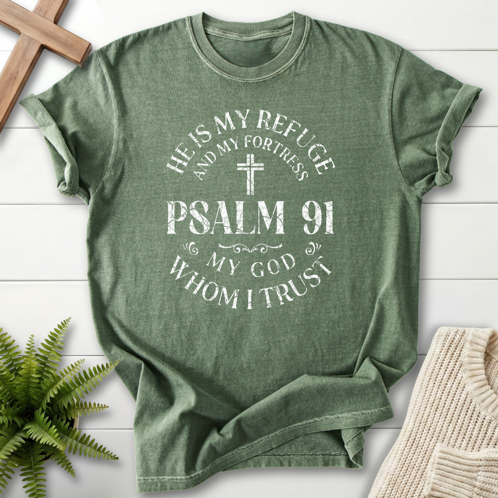 Moss green Bible verse tee with a distressed Psalm 91 badge design featuring 'He is My Refuge and My Fortress', inspired by Psalm 91.