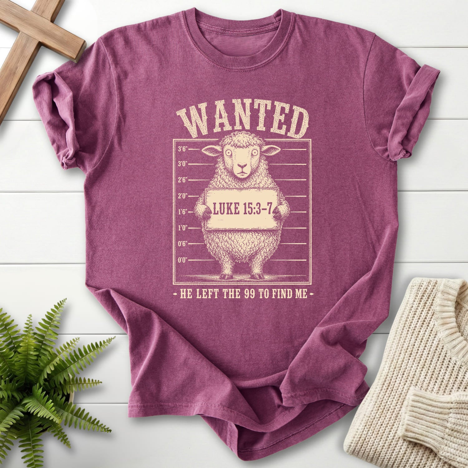 Flat lay of a Berry faith-based tee featuring "He Left the 99 to Find me Dark T-Shirt" Luke 15:3-7.