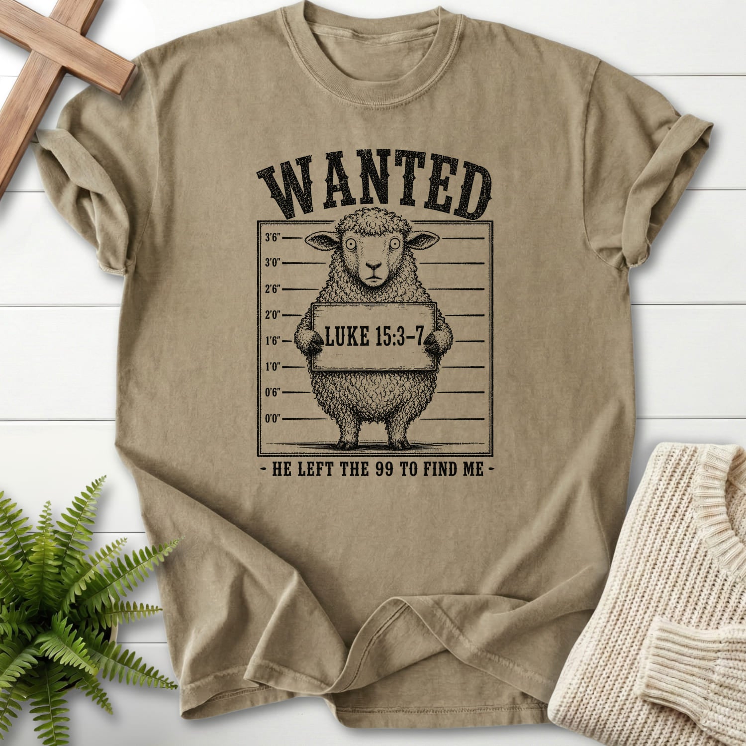 Flatlay of a Khaki Comfort Colors 1717 garment-dyed Christian tee with "He Left the 99 to Find me Dark T-Shirt" Luke 15:3-7 From Printify.